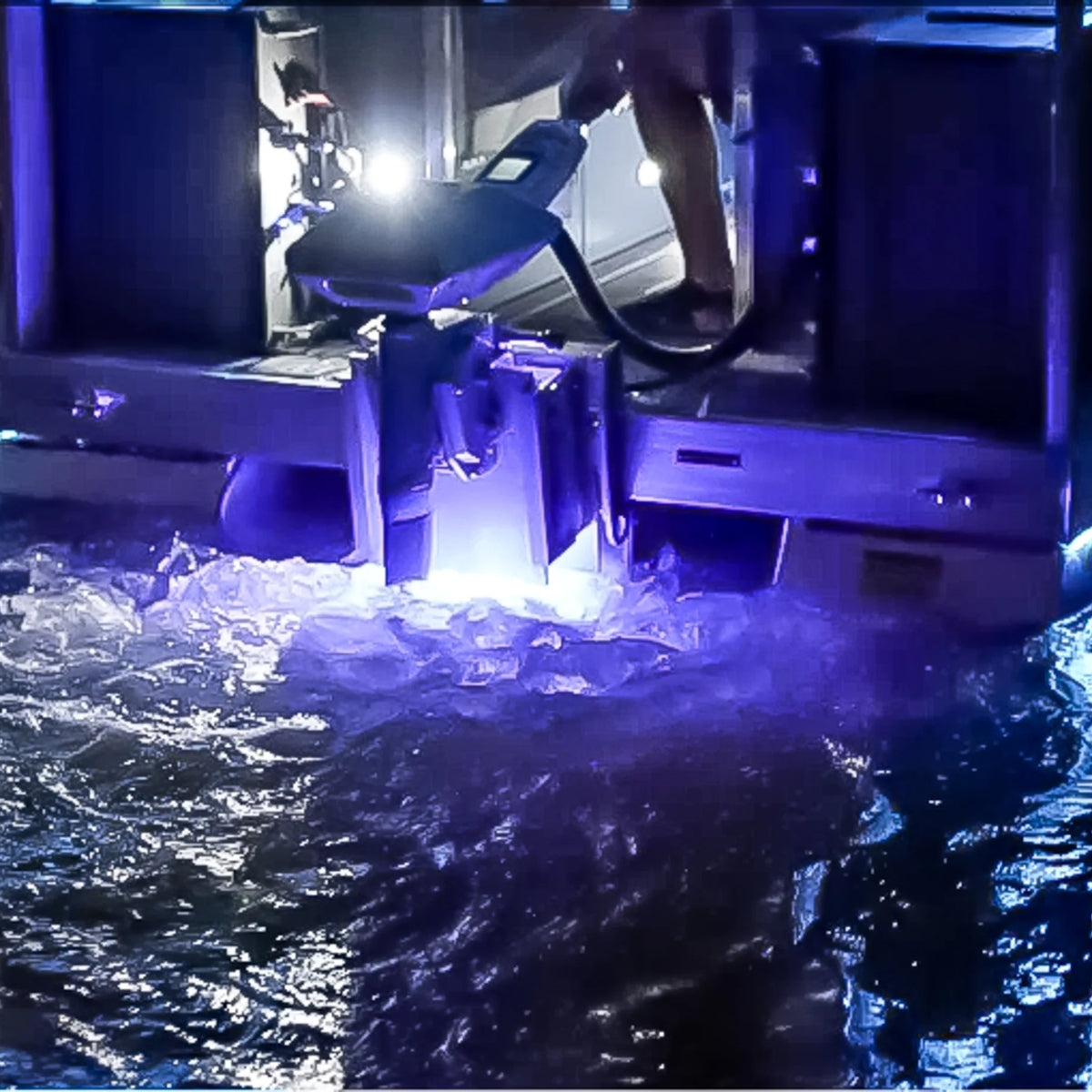 Plashlights EPIK underwater transom light illuminating water with a brilliant blue glow from a boat.