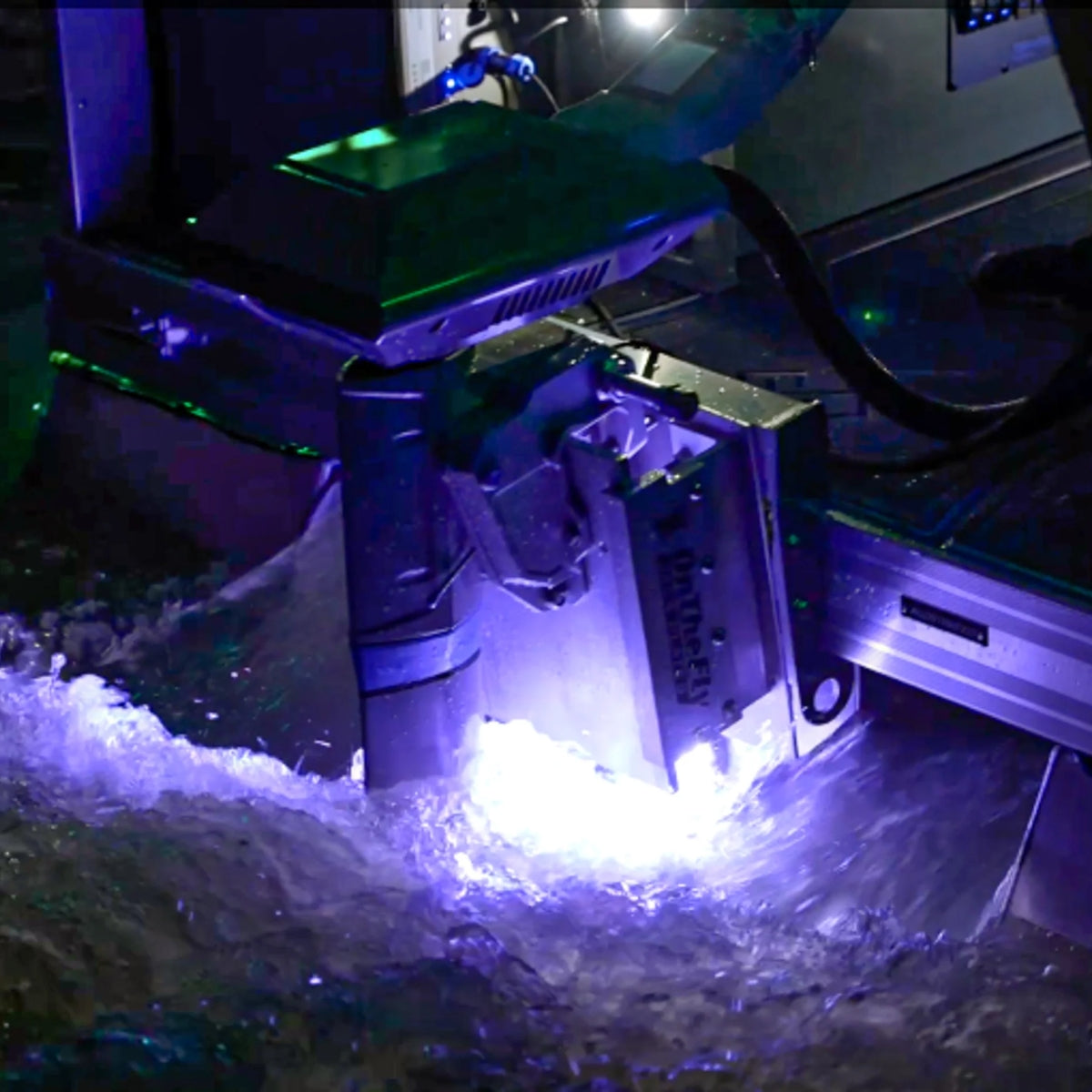 Plashlights EPIK underwater transom light illuminating water with a brilliant purple glow.