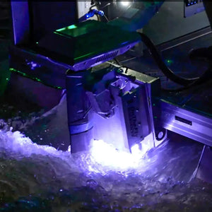 Plashlights EPIK underwater transom light illuminating water with a brilliant purple glow.