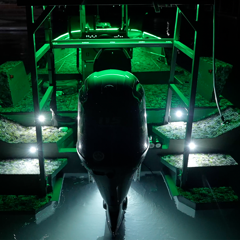 Plashlights EPIK dual color LED underwater transom lights illuminating a boat's stern with a vibrant green glow.