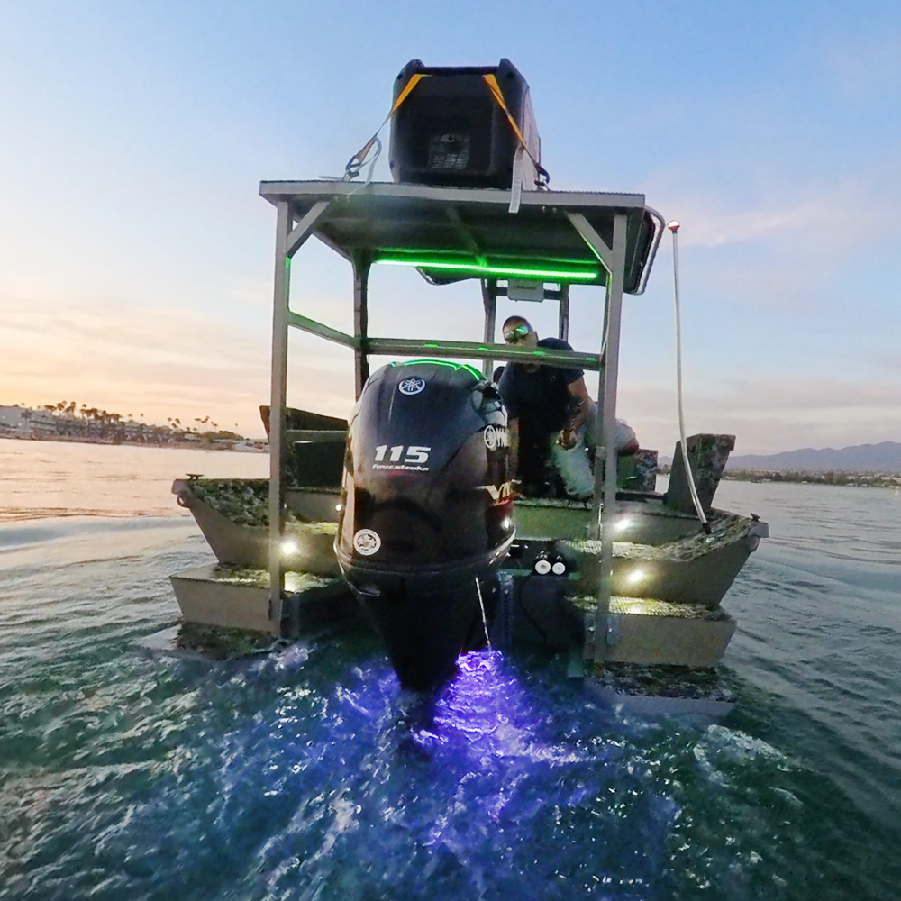 Boat with Plashlights EPIK underwater transom lights glowing blue, green deck lights, and a Yamaha 115 outboard.