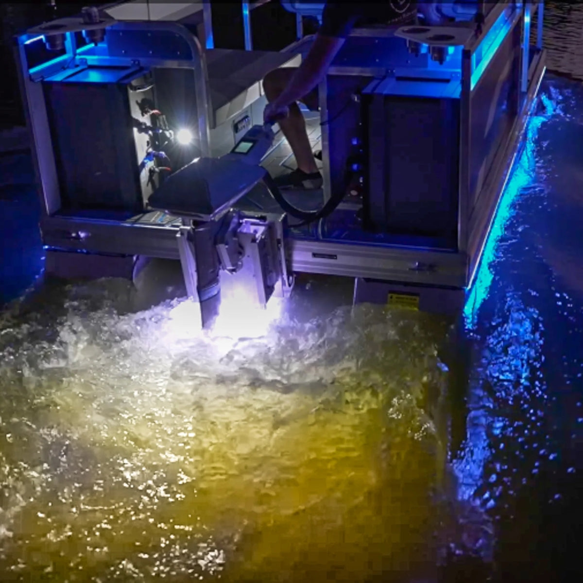 Plashlights EPIK dual-color LED transom lights illuminating boat wake with blue and warm white glow.