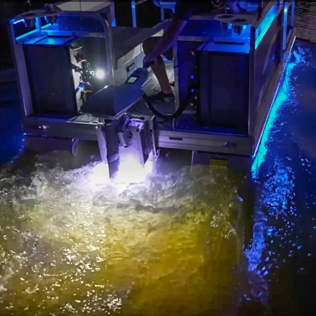 Plashlights EPIK dual-color LED transom lights illuminating boat wake with blue and warm white glow.