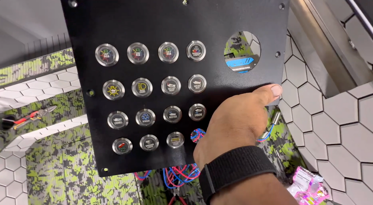 Black panel with 15 round, silver 22mm Plashlights REVERT switches, each with a unique icon.