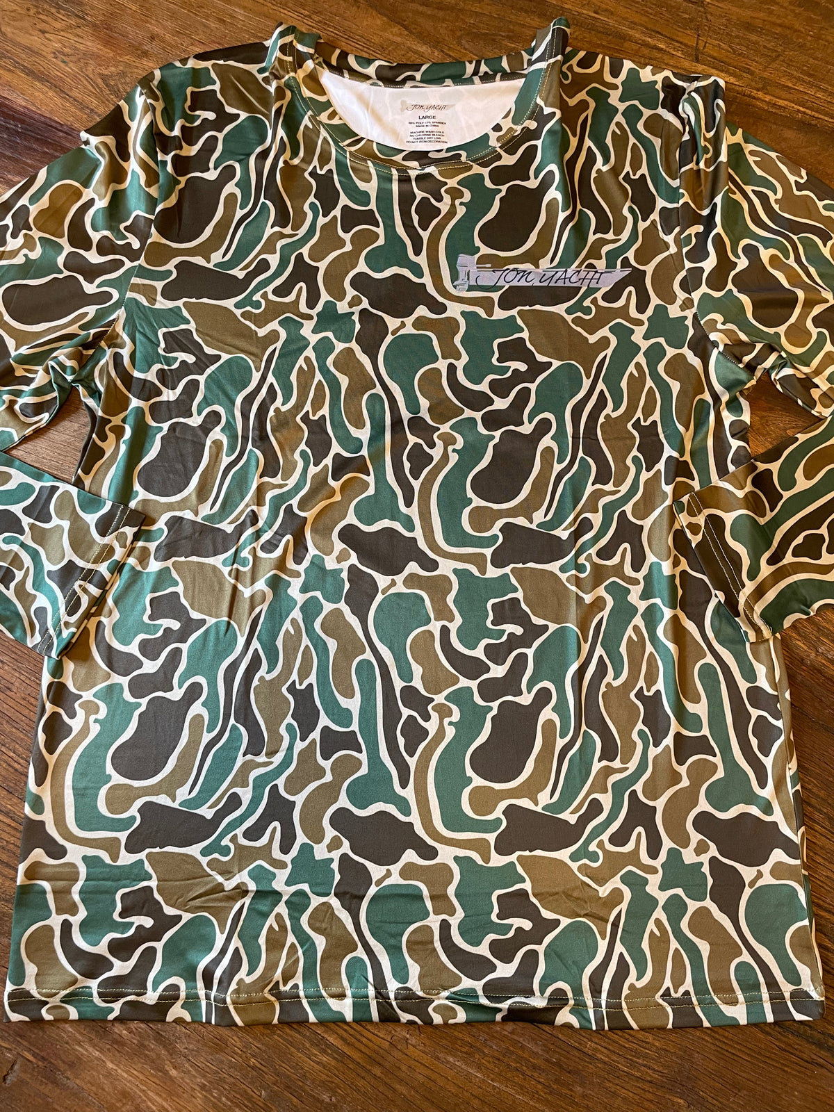 Pluff Mud Old School moisture-wicking sun shirt with a dark green, brown, and tan camouflage pattern.