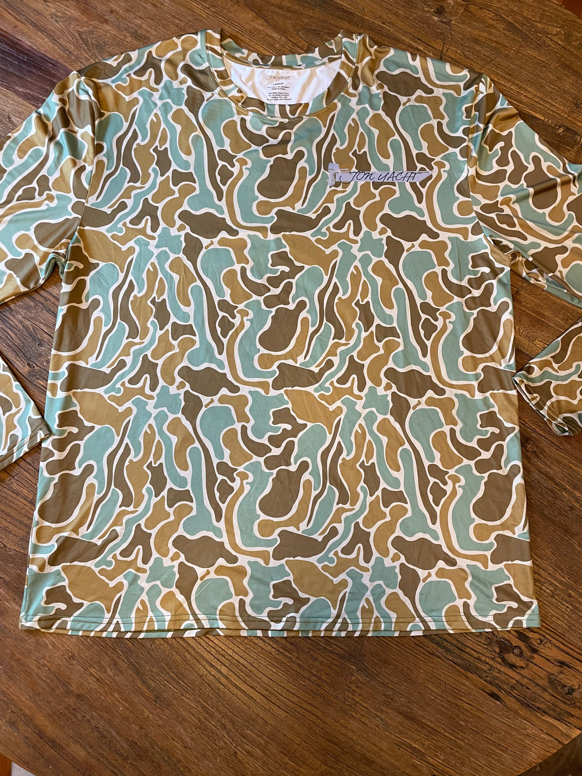 Pluff Mud Old School moisture-wicking sun shirt in brown, tan, and teal camouflage, with "Pluff Mud" logo.