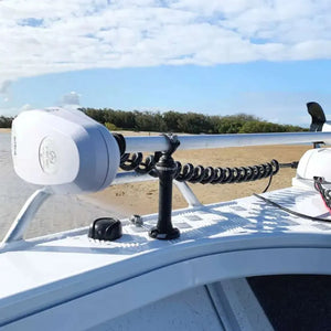 White RAILBLAZA StarPort Base mounted on a boat, securing a trolling motor with a black coiled cable.