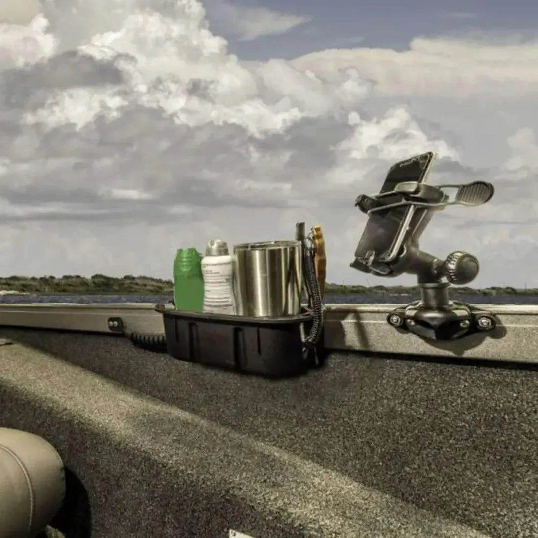 Black Railblaza Trackloader StarPort with phone holder and storage caddy mounted on a boat gunnel.
