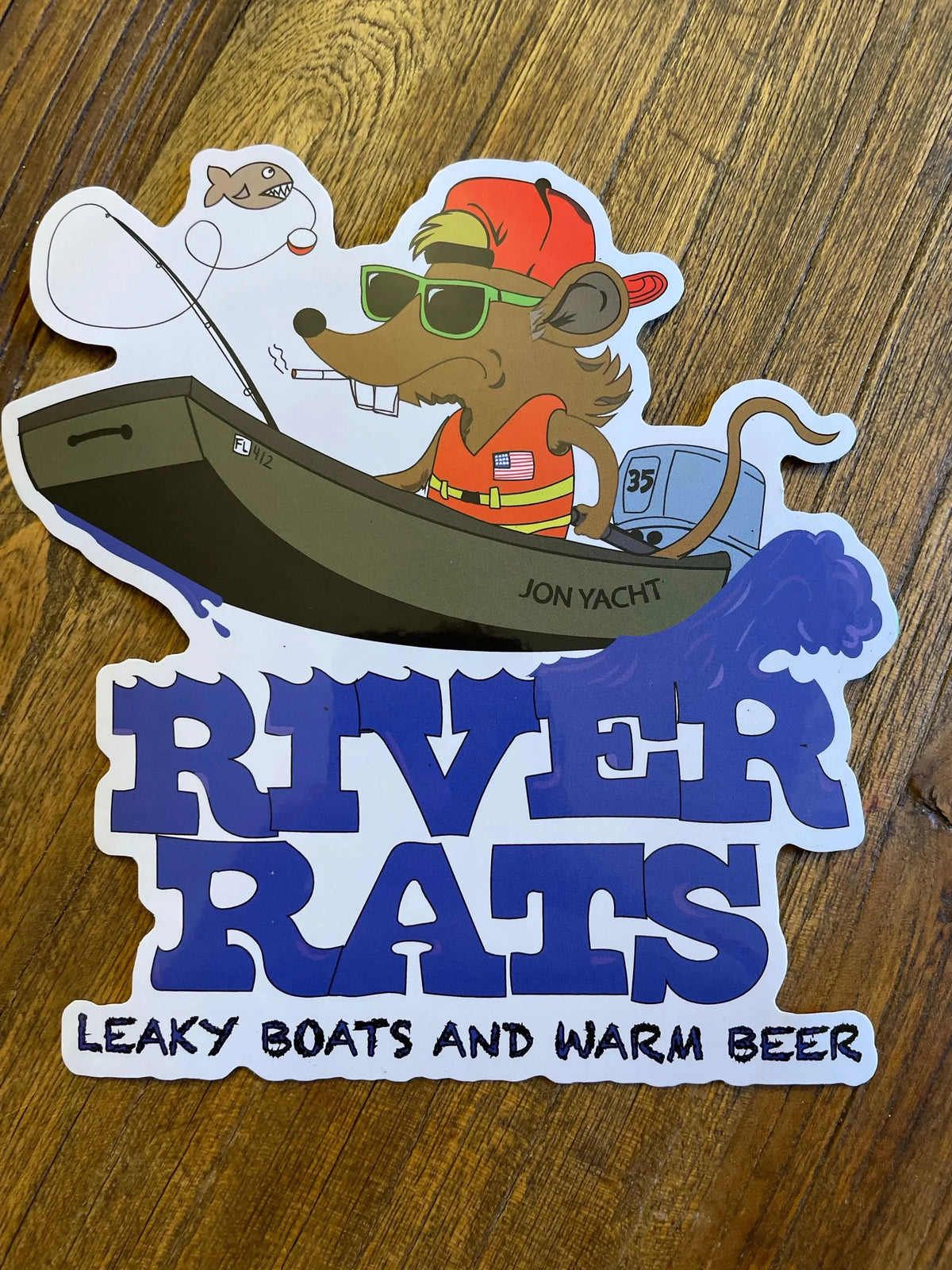 Cartoon rat in a boat with "River Rats" text, "Leaky Boats and Warm Beer" slogan.