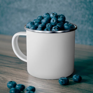 White 12oz enamel mug with a silver rim, filled with fresh blueberries, on a wooden surface.