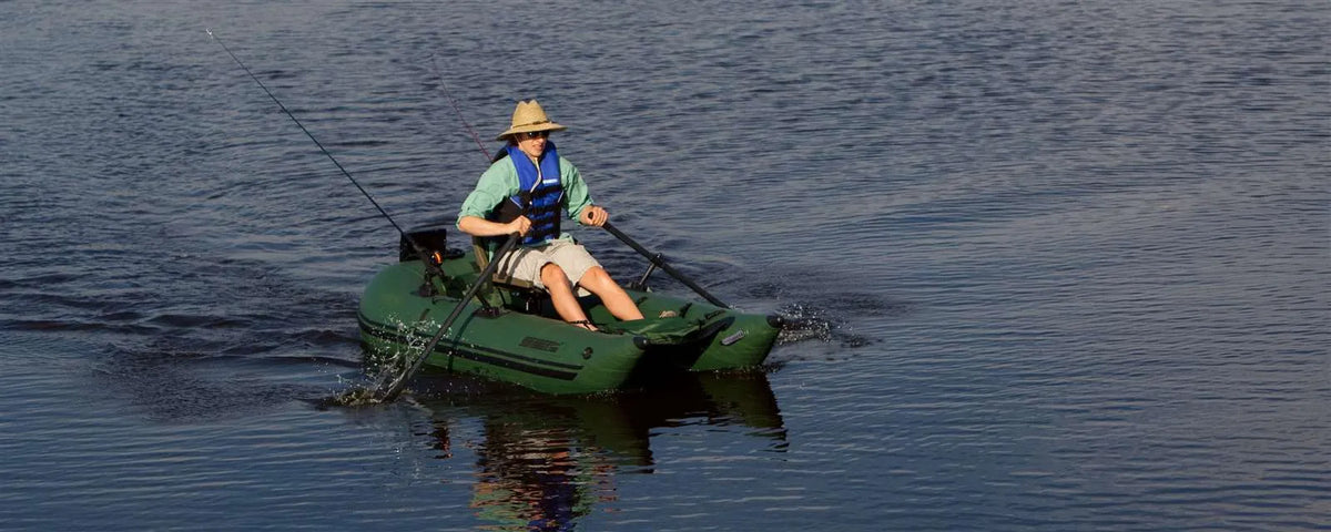 Hunter Green Sea Eagle 285 Frameless Pontoon Boat with a person rowing, fishing on calm water.