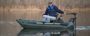 Man fishing from a Hunter Green Sea Eagle 285 frameless inflatable pontoon boat with a trolling motor.
