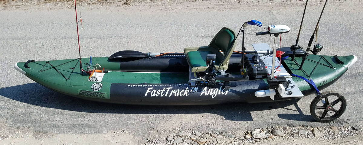 Green and black Sea Eagle 385fta FastTrack Angler inflatable kayak with fishing gear, motor, and cart.