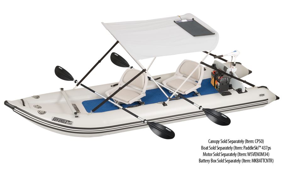 White inflatable Sea Eagle boat with a white canopy, two beige seats, black paddles, and a black semi-flexible solar panel.