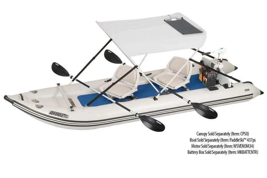 White inflatable Sea Eagle boat with a white canopy, two beige seats, black paddles, and a black semi-flexible solar panel.