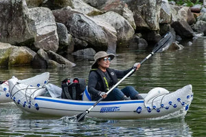 Woman in a Sea Eagle inflatable kayak paddles with a black and silver AB30 4-part paddle.
