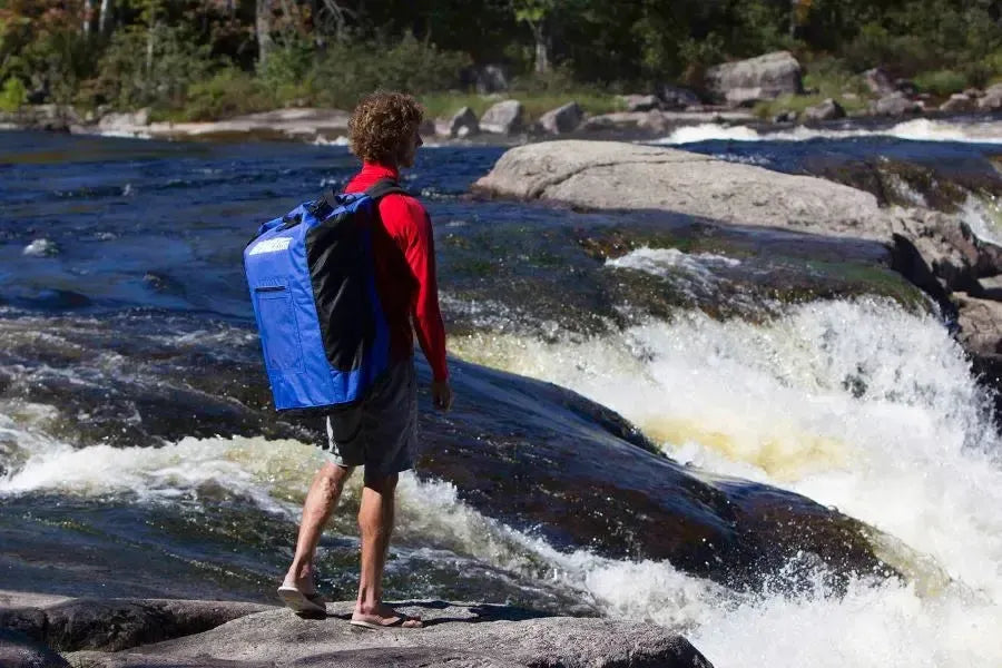 Large blue Sea Eagle backpack with black mesh sides, front pouch, and padded shoulder straps.