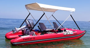 Red Sea Eagle FastCat12 inflatable catamaran with a white canopy, two seats, and a Honda outboard motor.
