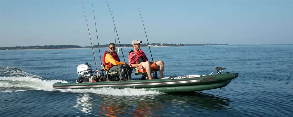 Two men fishing from a green Sea Eagle FishSkiff 16 inflatable boat with an outboard motor on calm water.