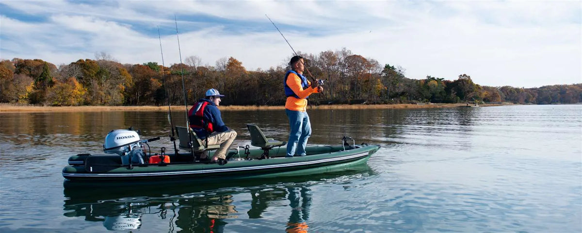Two men fishing from a green Sea Eagle FishSkiff 16 inflatable boat with a Honda outboard motor.