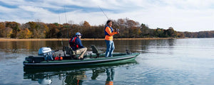 Two men fishing from a green Sea Eagle FishSkiff 16 inflatable boat with a Honda outboard motor.