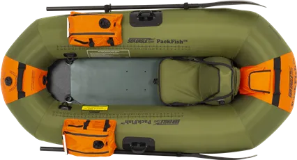 Top-down view of a green Sea Eagle PackFish7 inflatable fishing boat with orange storage bags, a seat, and oars.