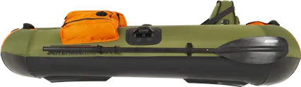 Green and black Sea Eagle PackFish7™ inflatable fishing boat with orange storage bag and black paddle.