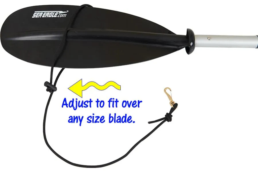 Black Sea Eagle paddle leash with adjustable shock cord and brass clip, attached to a paddle blade.