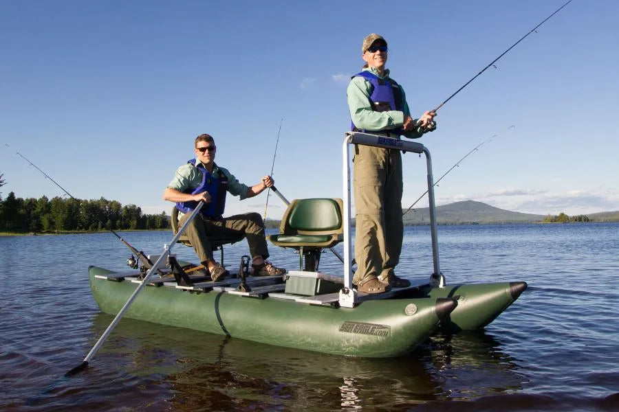 Two men fishing from a green Sea Eagle inflatable boat on a lake.