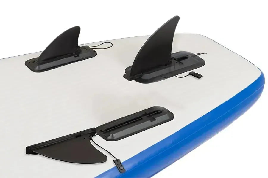 Three black Sea Eagle skeg bases with fins attached to a white and blue inflatable SUP or kayak.