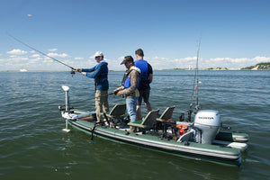 Green Sea Eagle inflatable boat with two tandem locking swivel seats and 7" pedestals, carrying three anglers.