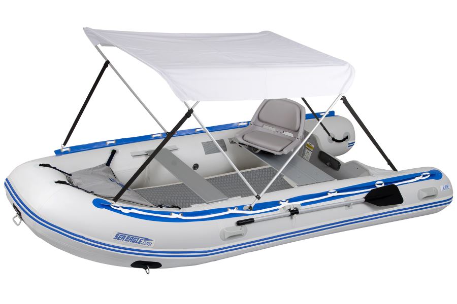 White Sea Eagle Wide Sun &amp; Rain Canopy on an inflatable boat with blue trim and gray seat.