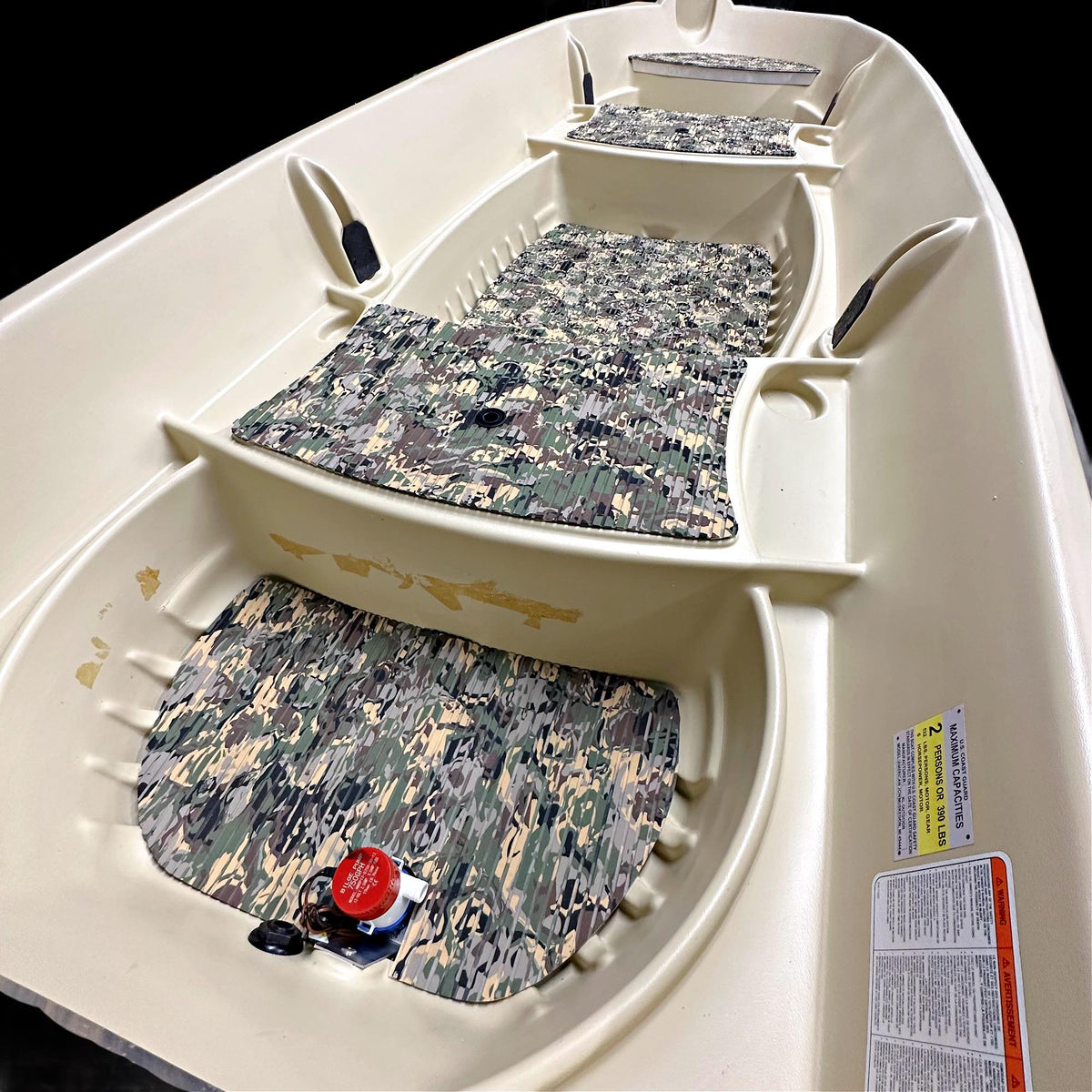 Beige Sun Dolphin American 12 boat interior with three camouflage EVA foam floor mats.