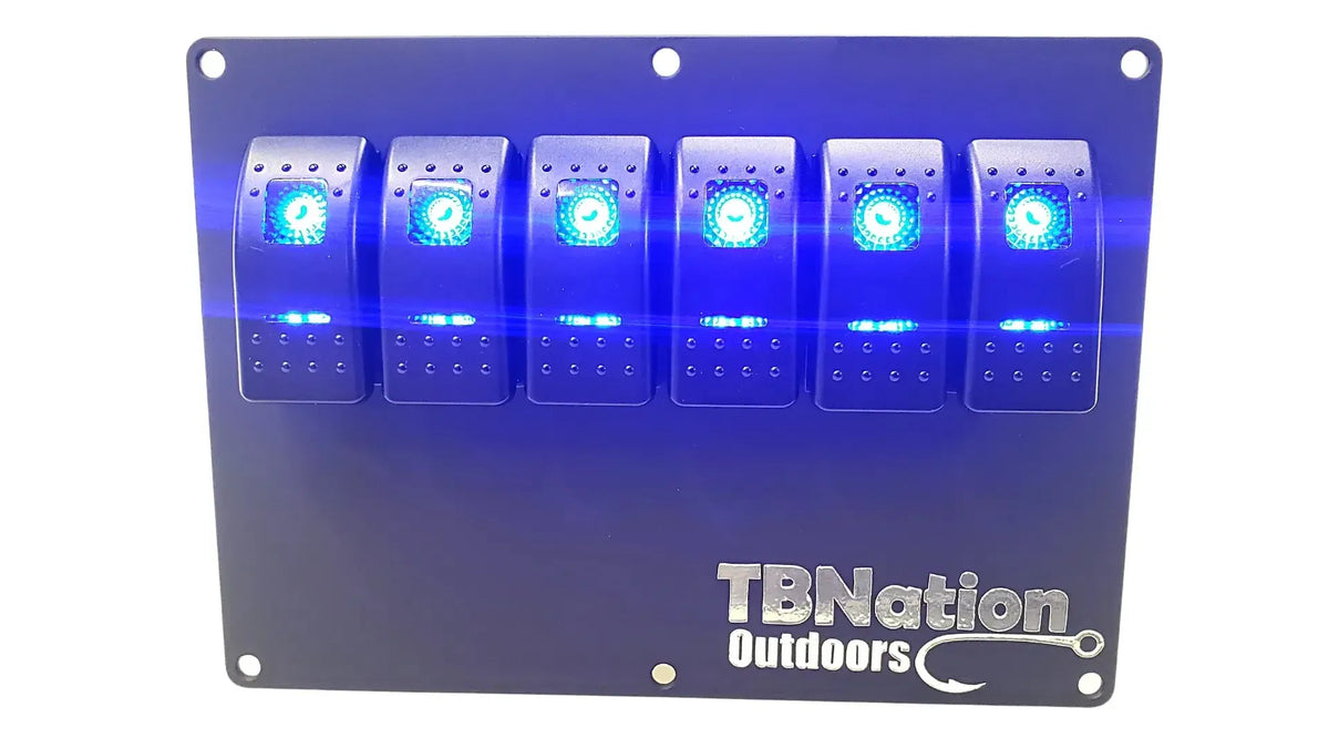 Black 6-gang TBNation Outdoors hydro-dipped aluminum switch panel with six glowing blue rocker switches.