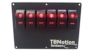 Black 6-gang TBNation Outdoors hydro-dipped aluminum rocker switch panel with six red illuminated switches.