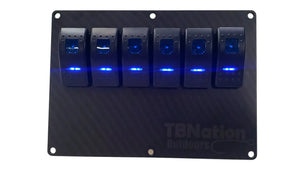 TBNation 6-gang carbon fiber hydro-dipped aluminum switch panel with six blue LED rocker switches.