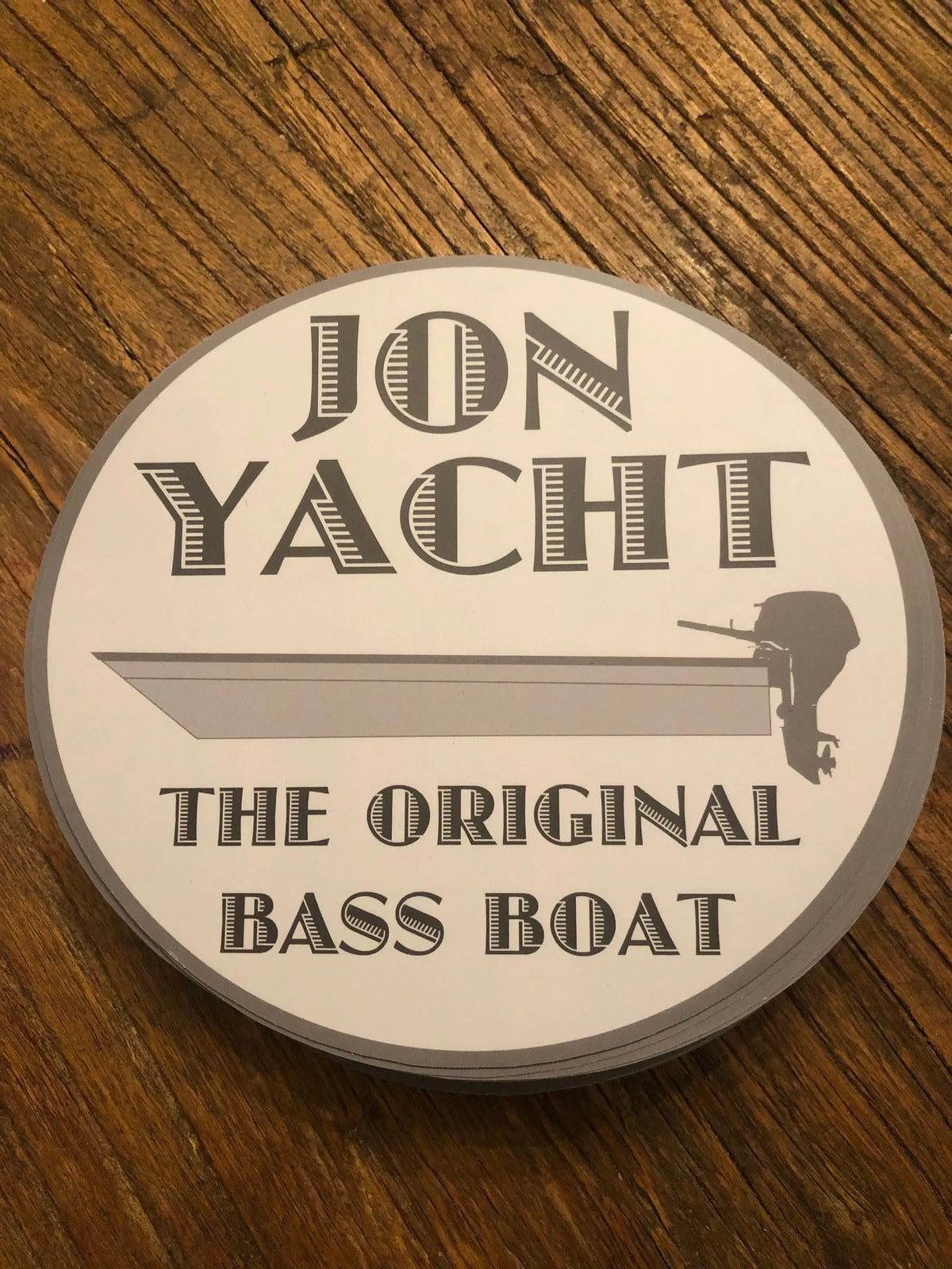 Oval white and gray "JON YACHT THE ORIGINAL BASS BOAT" sticker with a jon boat and outboard motor graphic.