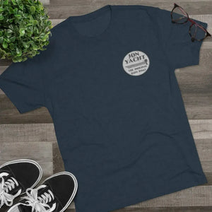 Navy tri-blend tee with "Jon Yacht The Original Bass Boat" logo, black sneakers, plant, and glasses.