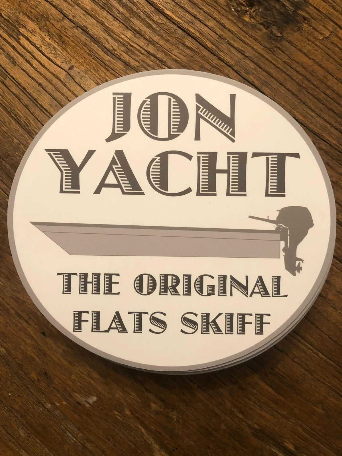 White oval "Jon Yacht The Original Flats Skiff" sticker with a grey skiff boat design.