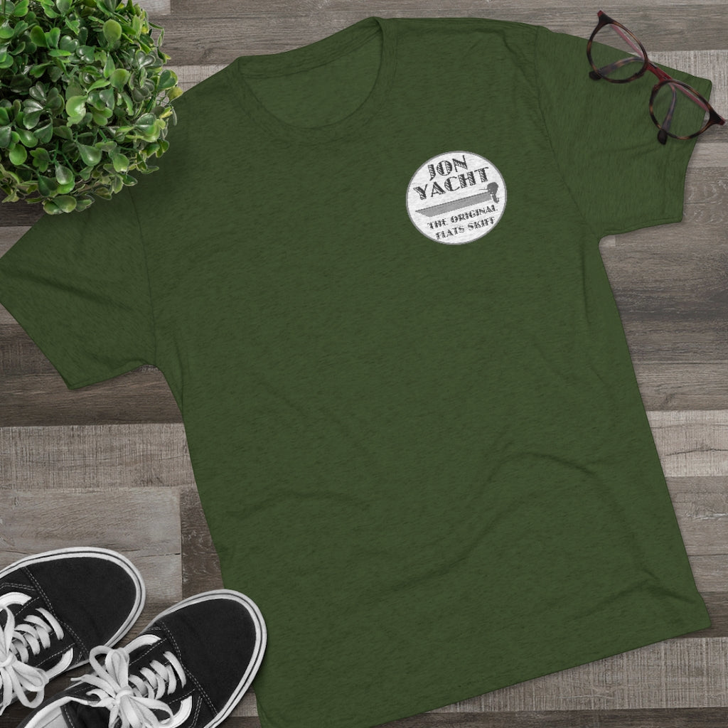 Dark green "Jon Yacht The Original Flats Skiff" graphic tee, soft cotton, with black sneakers and glasses.