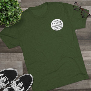 Dark green "Jon Yacht The Original Flats Skiff" graphic tee, soft cotton, with black sneakers and glasses.