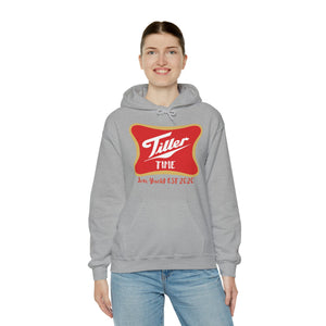 Woman smiling in a grey Tiller Time hoodie with a red and gold graphic, kangaroo pocket, and drawstring hood.