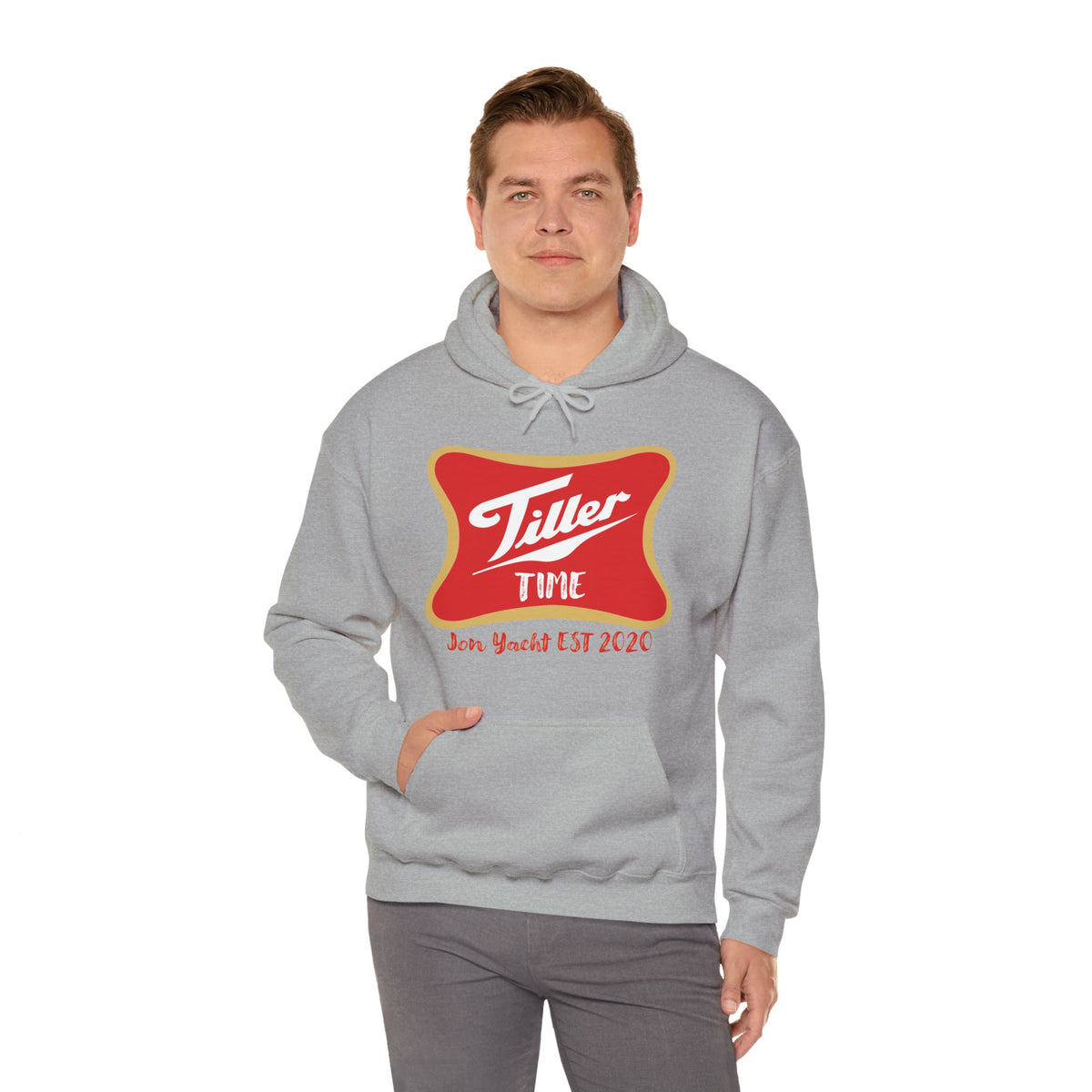 Man wearing a gray Tiller Time hoodie with a red and gold graphic, featuring a kangaroo pocket.