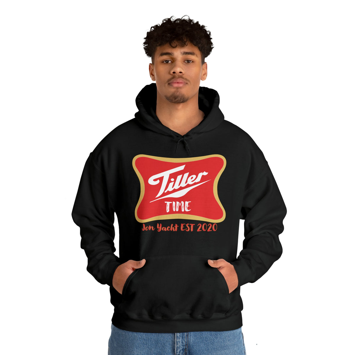 Young man in a black Tiller Time hoodie with red and gold logo, kangaroo pocket, and matching drawstring.