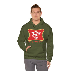 Man wearing an olive green Tiller Time hoodie with a red and gold graphic, featuring a kangaroo pocket.