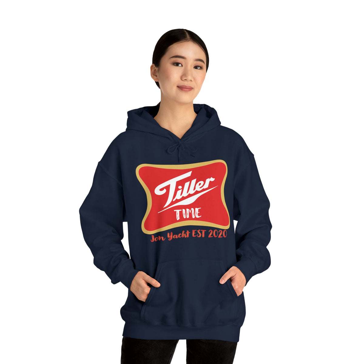 Woman wearing a navy "Tiller Time" hoodie with a red and gold logo, featuring a kangaroo pocket.