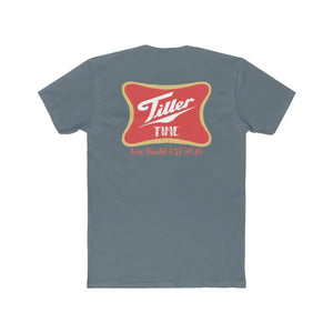 Slate blue combed cotton T-shirt with a red and gold "Tiller Time Jon Yacht EST 2020" graphic on the back.