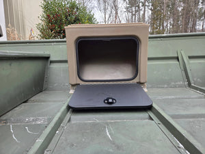 Tan universal jon boat tiller console with open black lid and latch, mounted on a green boat.