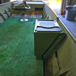 Olive green Universal Jon Boat Tiller Console with black top, mounted in a jon boat with green carpet.