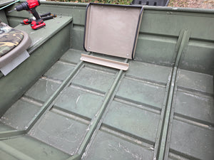 Empty olive green jon boat interior with a beige tiller console and seat back.